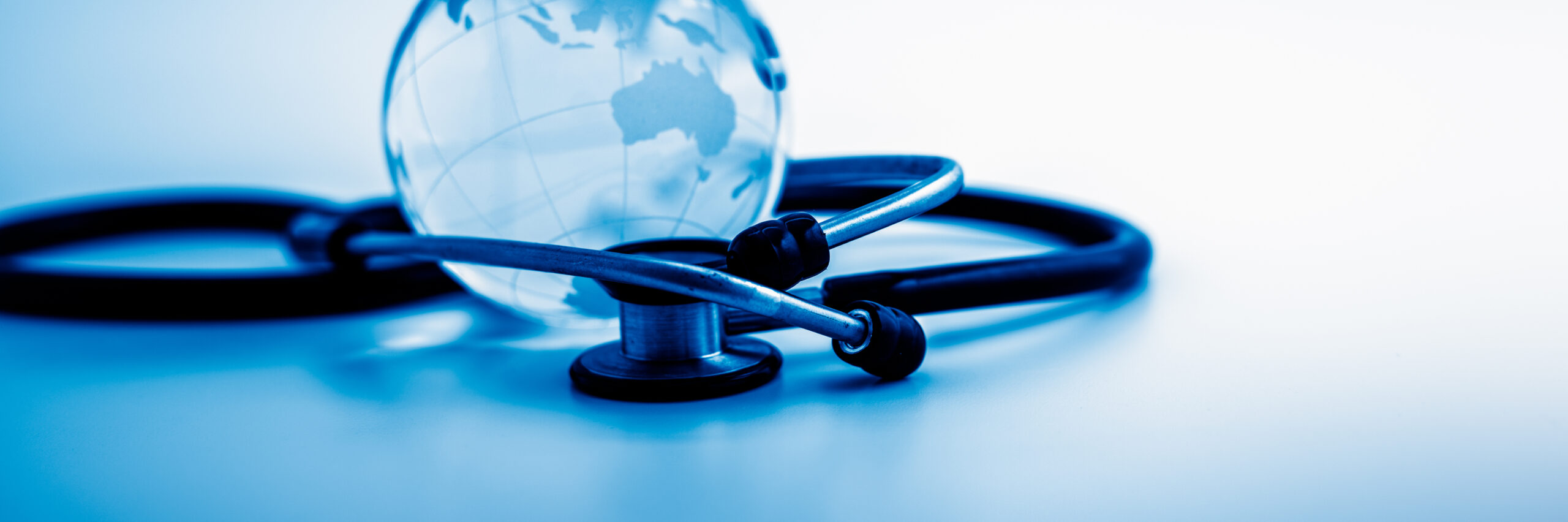 stethoscope around a small world glob, blue toned image